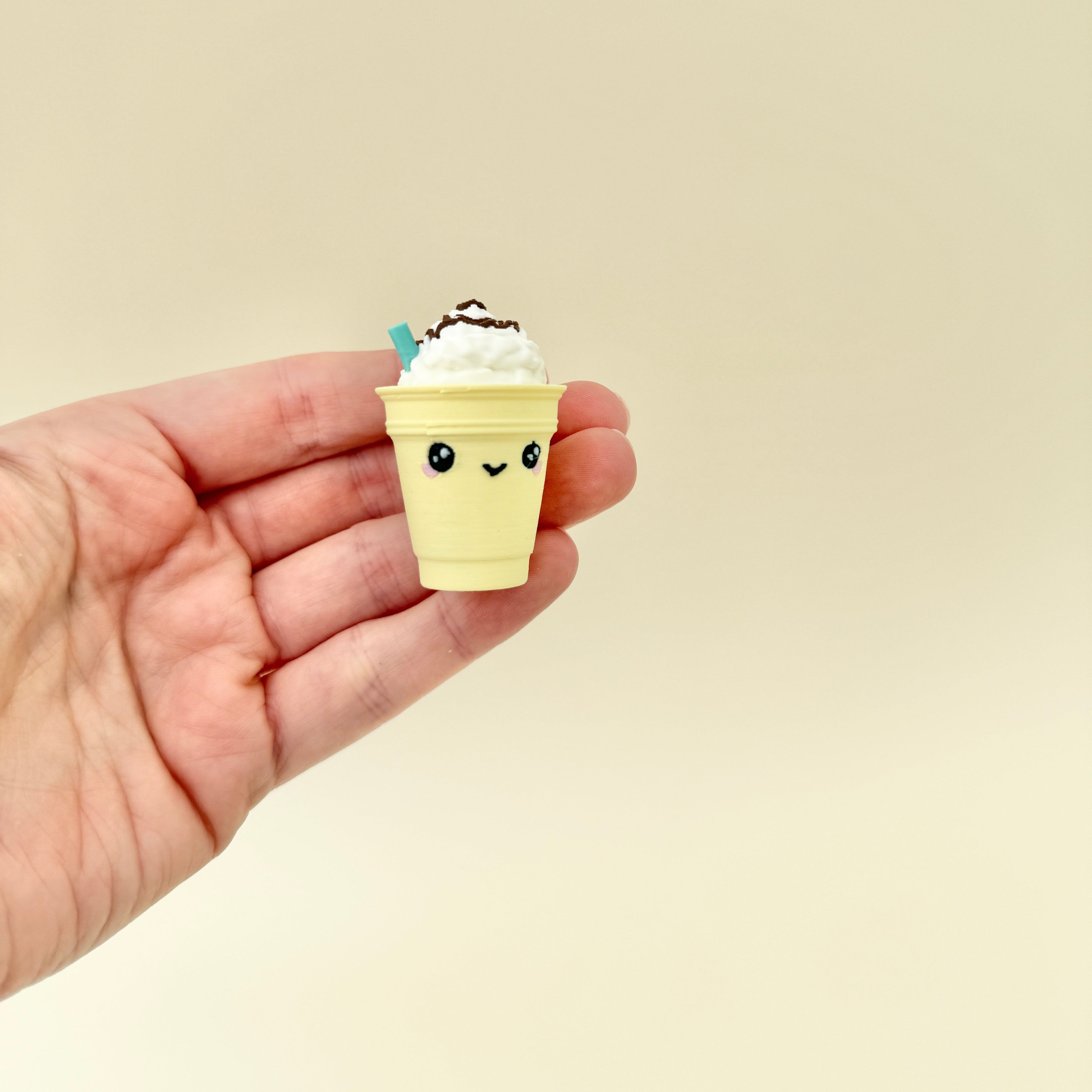A compact sensory toy with a pressable whipped cream top for a satisfying click.