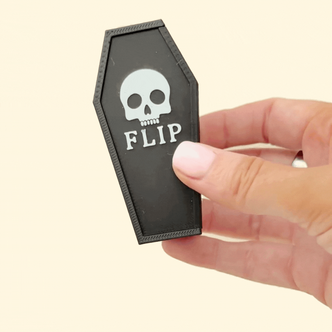 Magnetic fidget tiles with textured and smooth sides, shown beside a matching coffin case.

