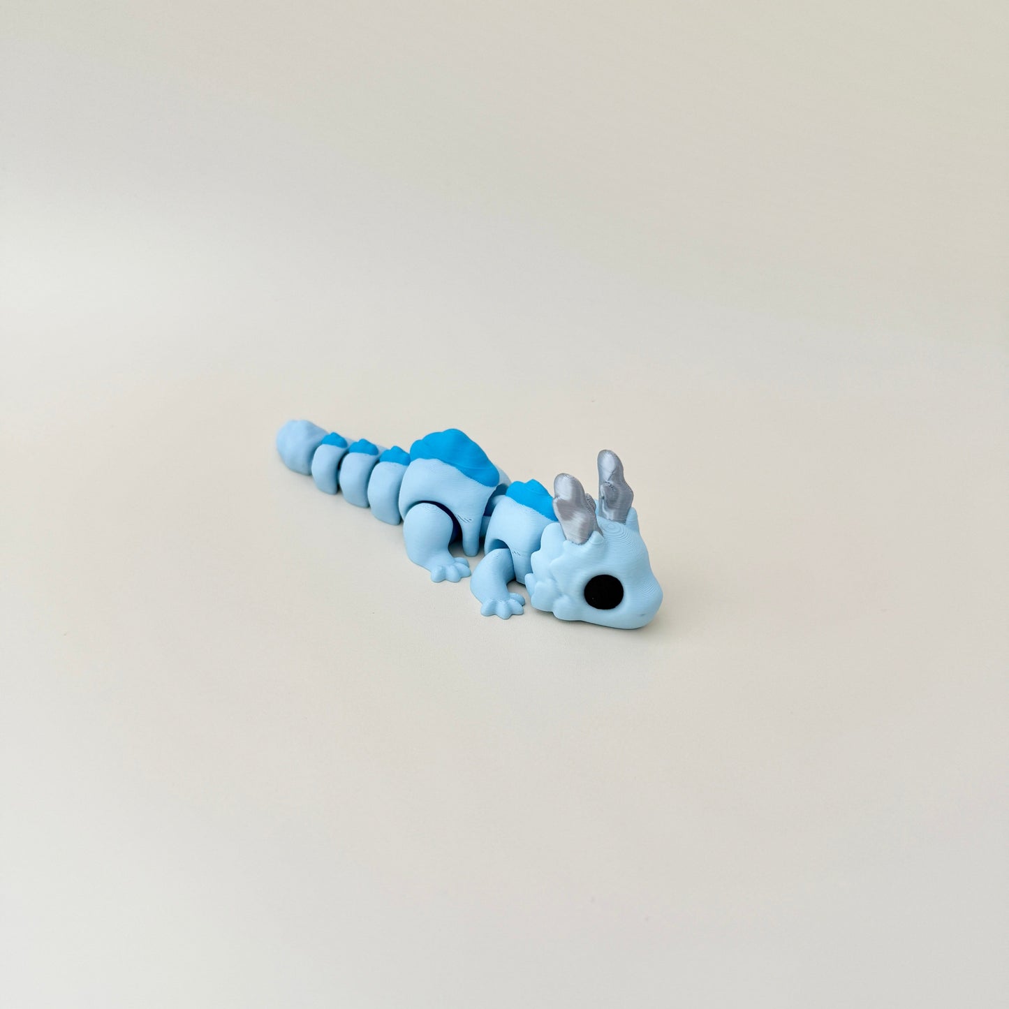 Skyburst Dragon in stunning blue tones and silver horns, perfect for sensory play or display.