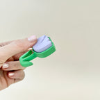 Lilac and green tulip-shaped clicker fidget toy, great for stress relief and sensory play.