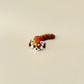 A collectable red panda fidget toy with intricate details, white facial markings, and a colour-changing filament.