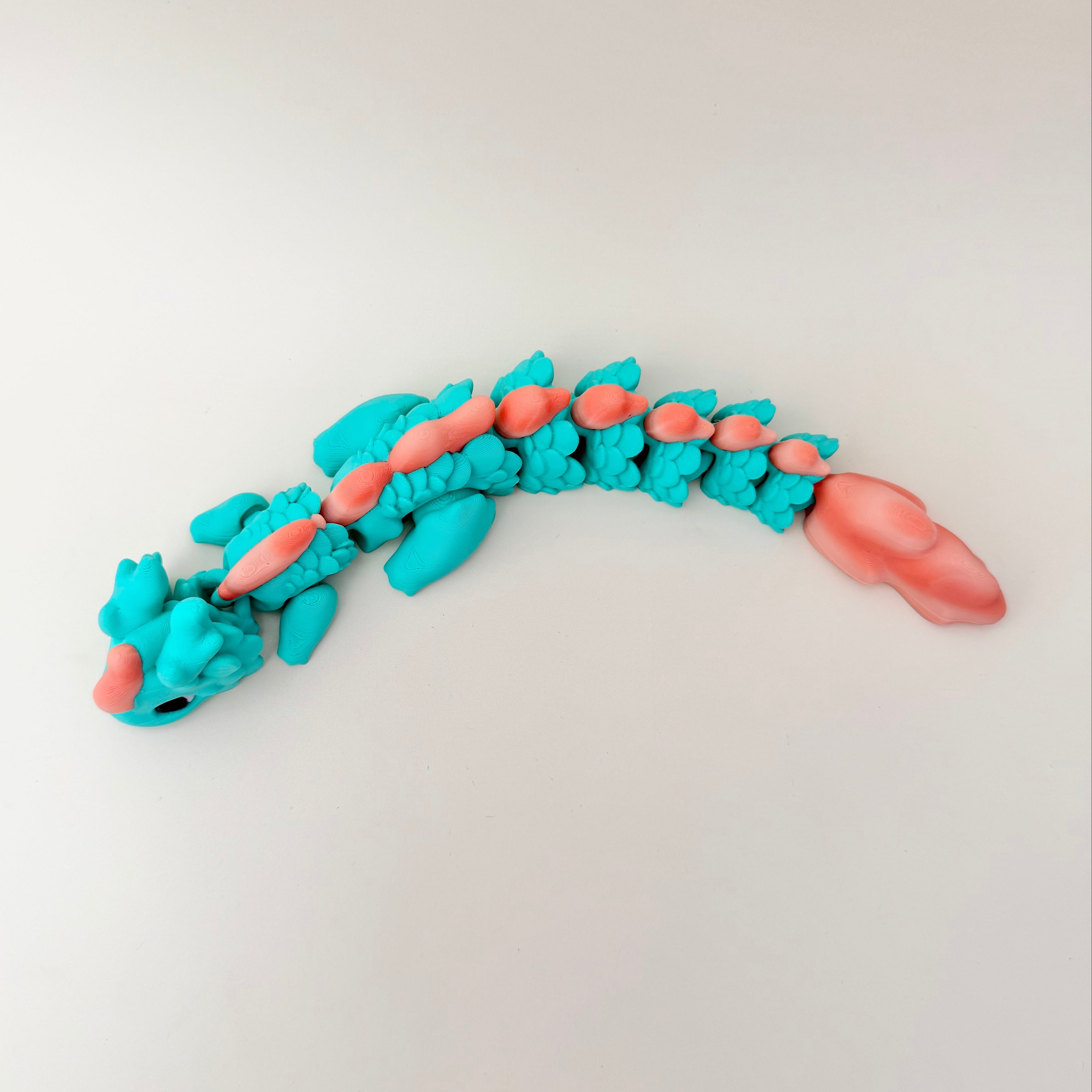 Striking aqua-coral finish; durable PLA build; great for display or everyday stimming for teens and adults.
