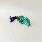 Articulated fidget dragon in dynamic colour-changing filament, measuring 18cm in length.
