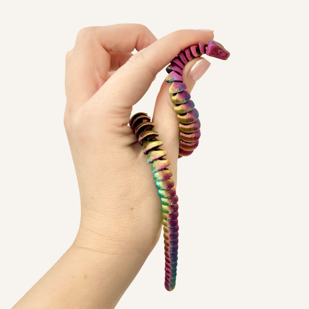 Fully articulated snake fidget toy with a 25cm colour-changing body in blue, green, gold, and purple.