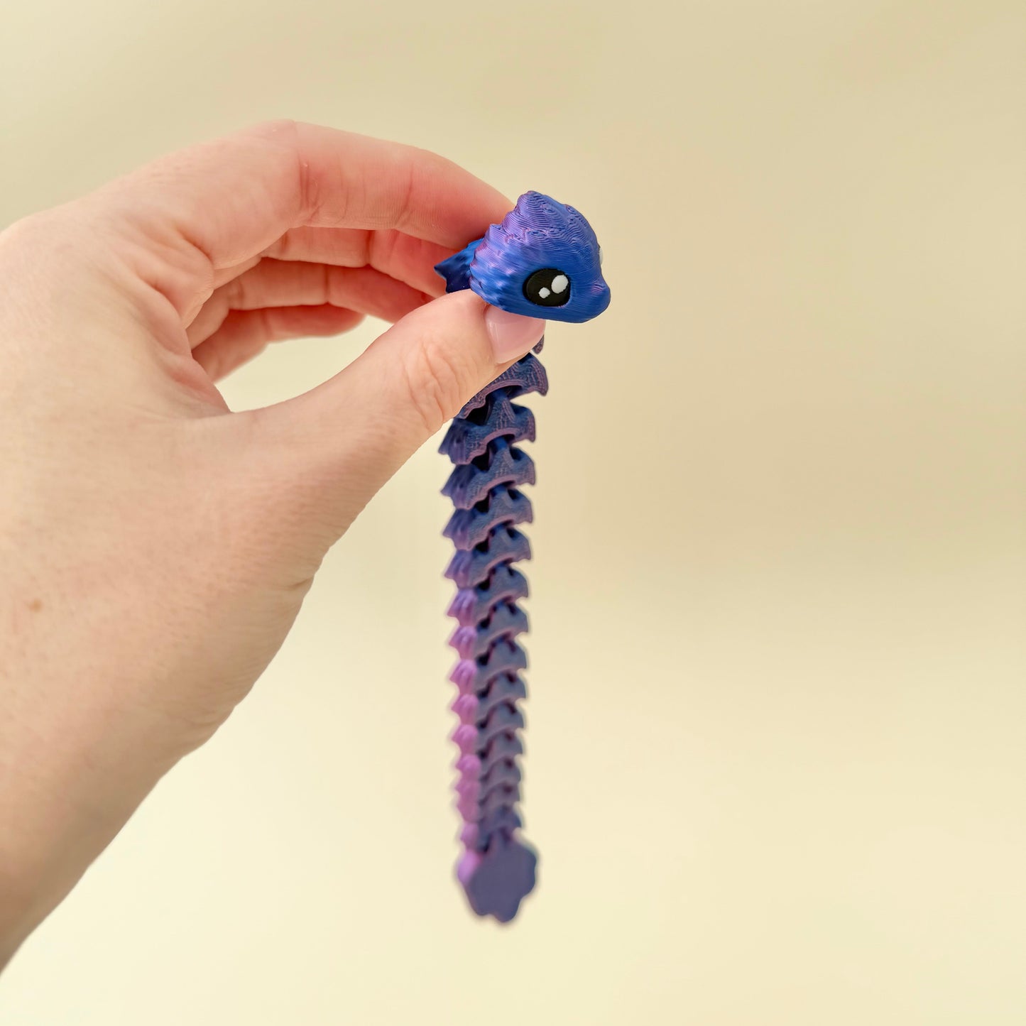 Cool-toned filament that changes hue with light and motion; low-noise fidget toy.
