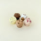 Small muffin-shaped fidget toys that click when pressed, ideal for quiet stimming.
