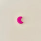 Small crescent moon fidget toy with satisfying click motion in pink hues.