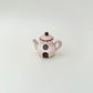Desk-friendly teapot fidget that doubles as a cute decorative piece.

