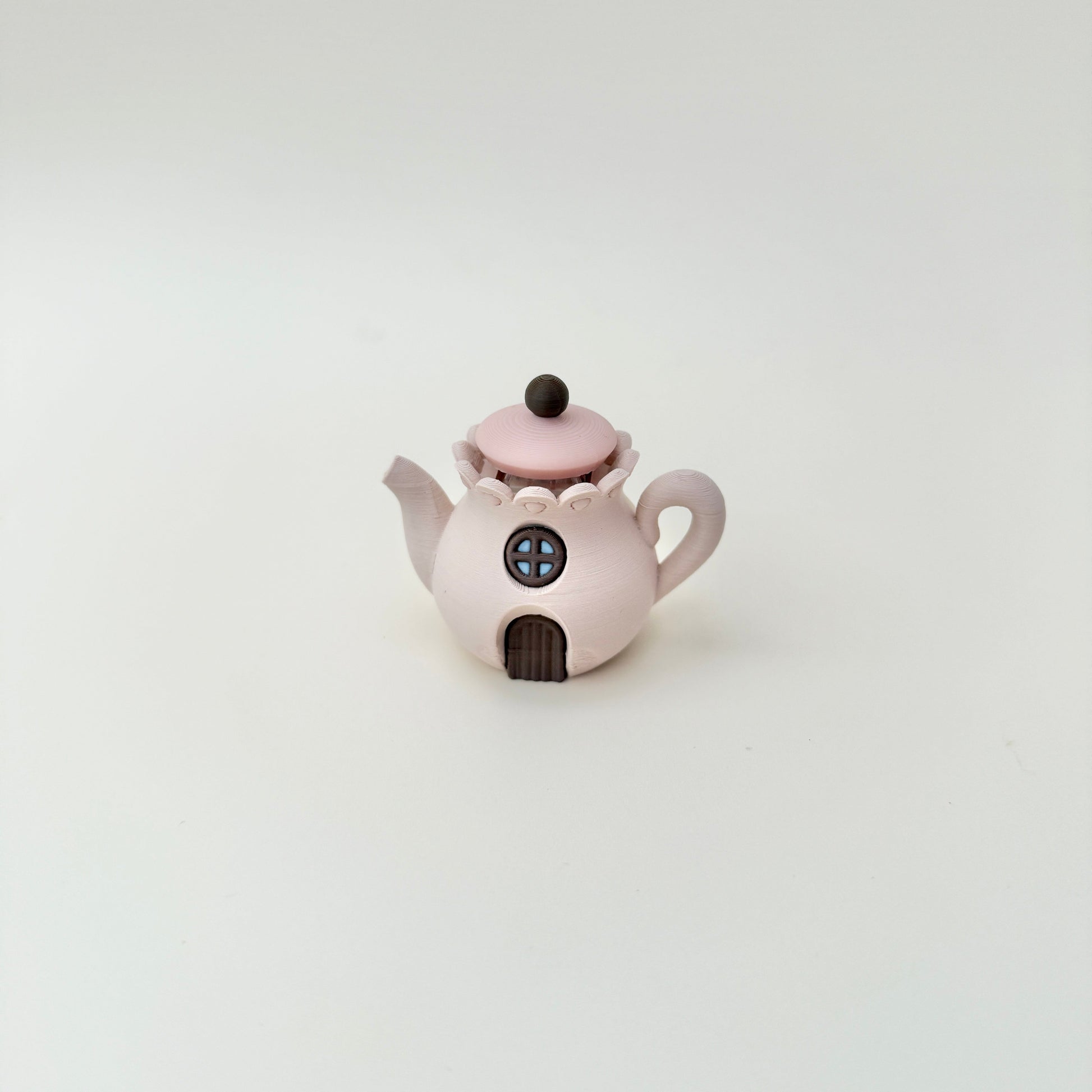 Desk-friendly teapot fidget that doubles as a cute decorative piece.
