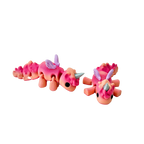 Baby Unicorn fidget toy with coral tones of red and peach, lilac wings, and a silver horn.