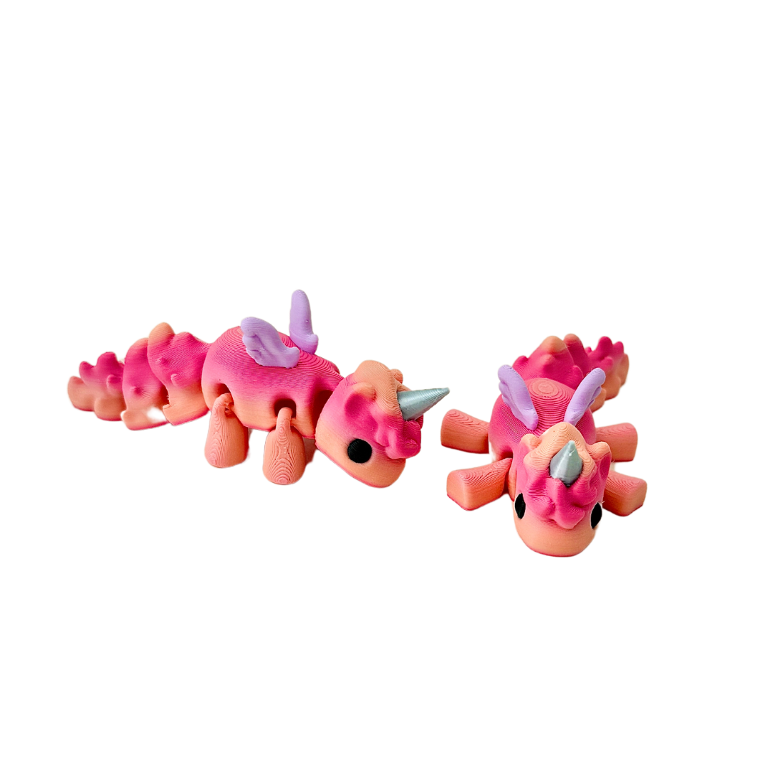 Baby Unicorn fidget toy with coral tones of red and peach, lilac wings, and a silver horn.