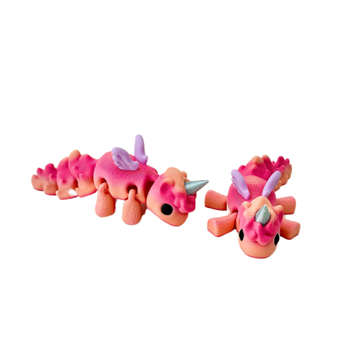 Baby Unicorn fidget toy with coral tones of red and peach, lilac wings, and a silver horn.