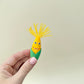 Two corn-themed fidget toys with hinged mouths and textured kernels, supplied with a small dish.
