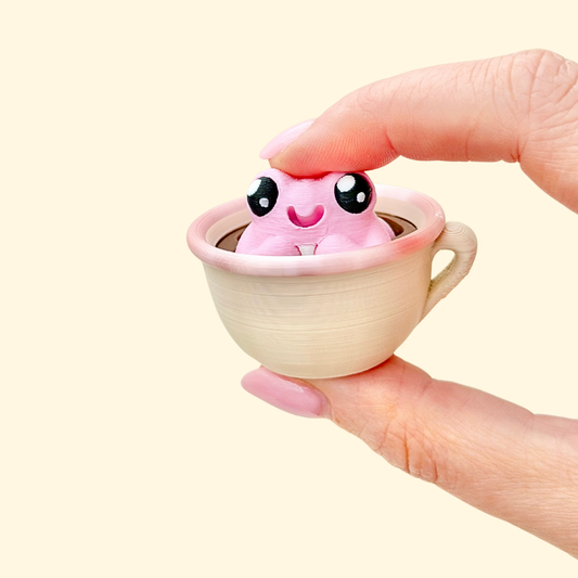 Teacup frog clicker fidget with push-down action for sensory stimming, focus support, and stress relief.
