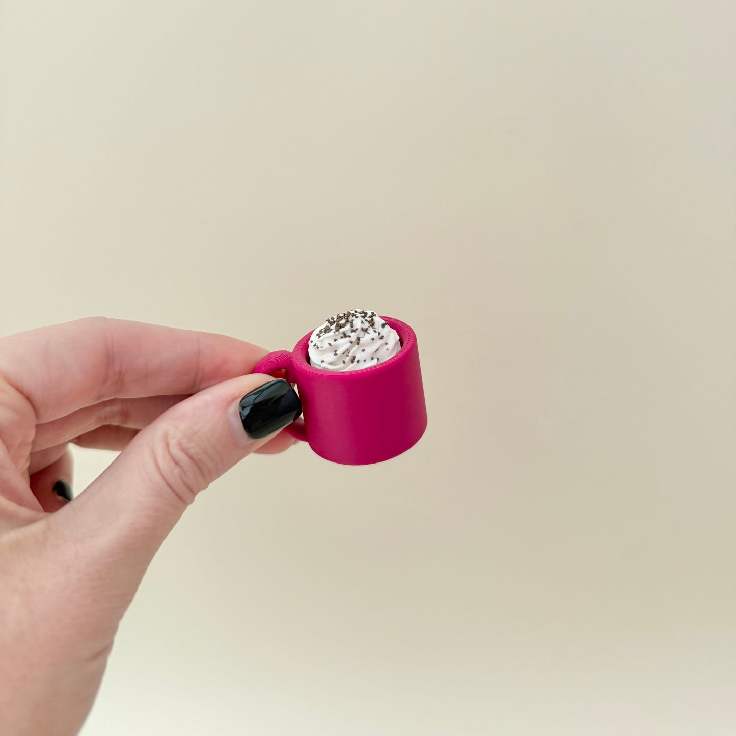 Mini mug clicker for pockets and desks; smooth cup, tactile top; optional quiet version for low-noise spaces.
