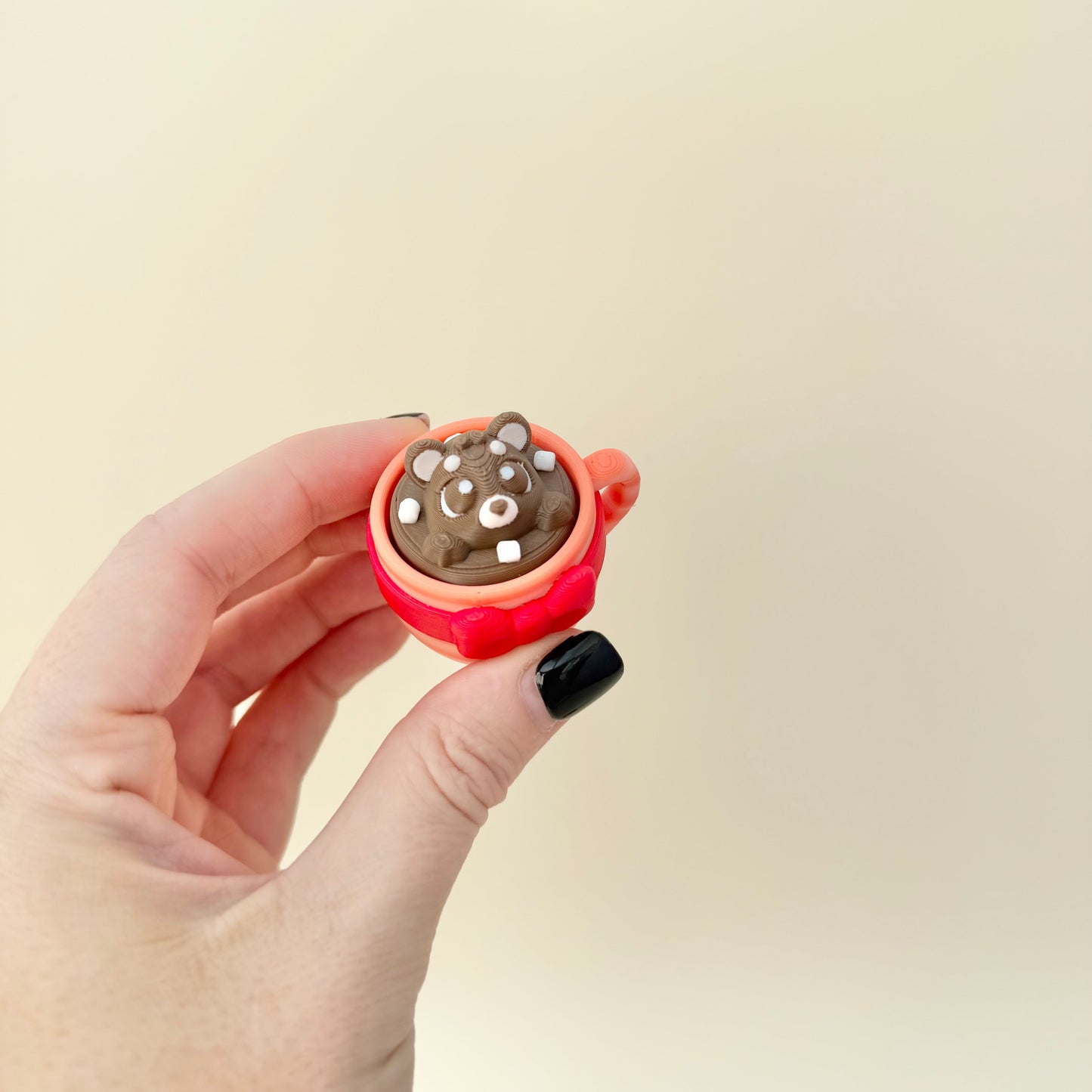 Cute Christmas hot chocolate stim toy with mixed textures for thumb tracing.
