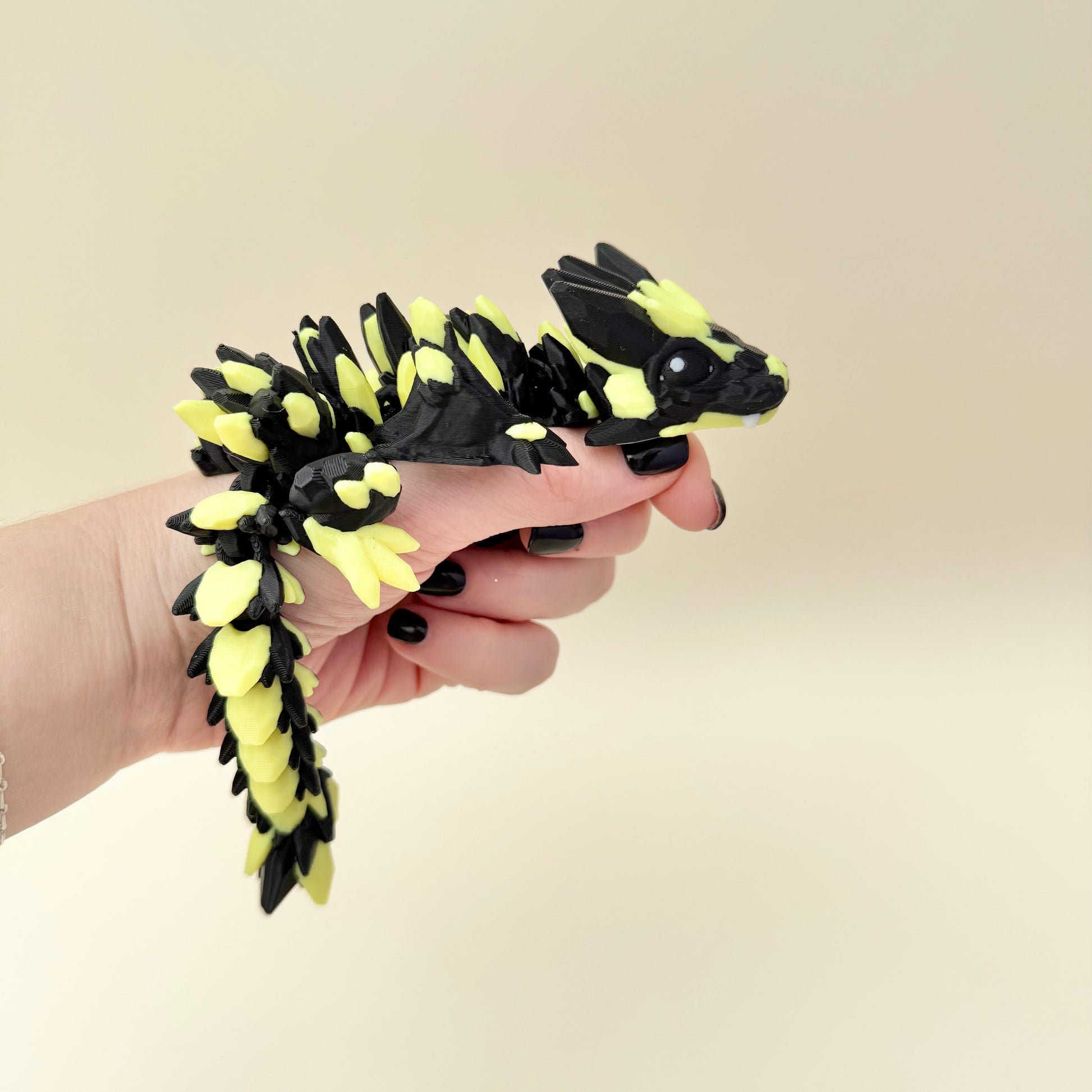 Glow-in-the-dark yellow/green crystal-textured articulated dragon with black accents.
