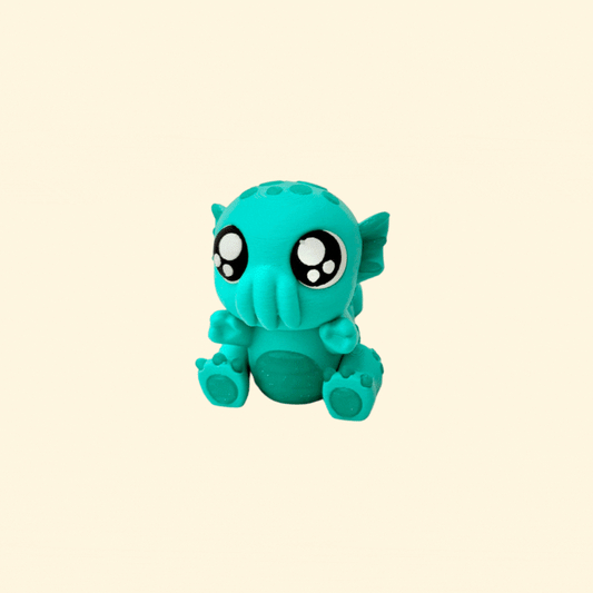 Small teal fidget toy inspired by mythical creatures with moveable limbs and tail