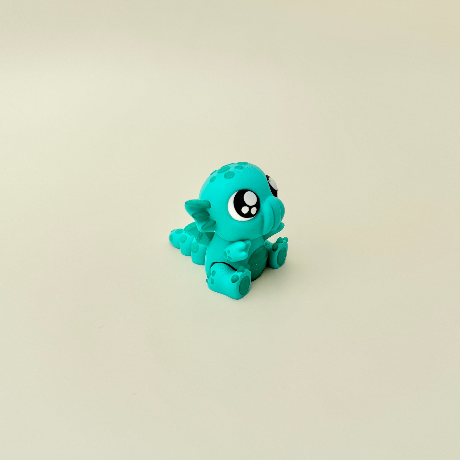 Compact articulated fidget toy with large eyes and textured features for sensory play