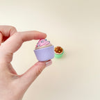 Demonstration of a cupcake clicker being pressed, making a satisfying clicking sound.