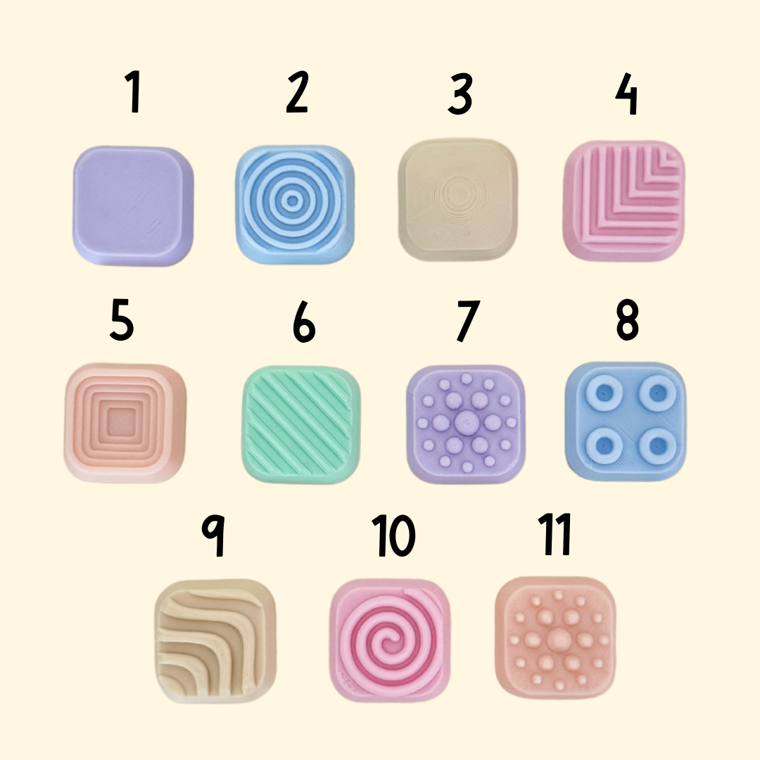 Clicker-style fidget with five pressable panels and varied surface textures.