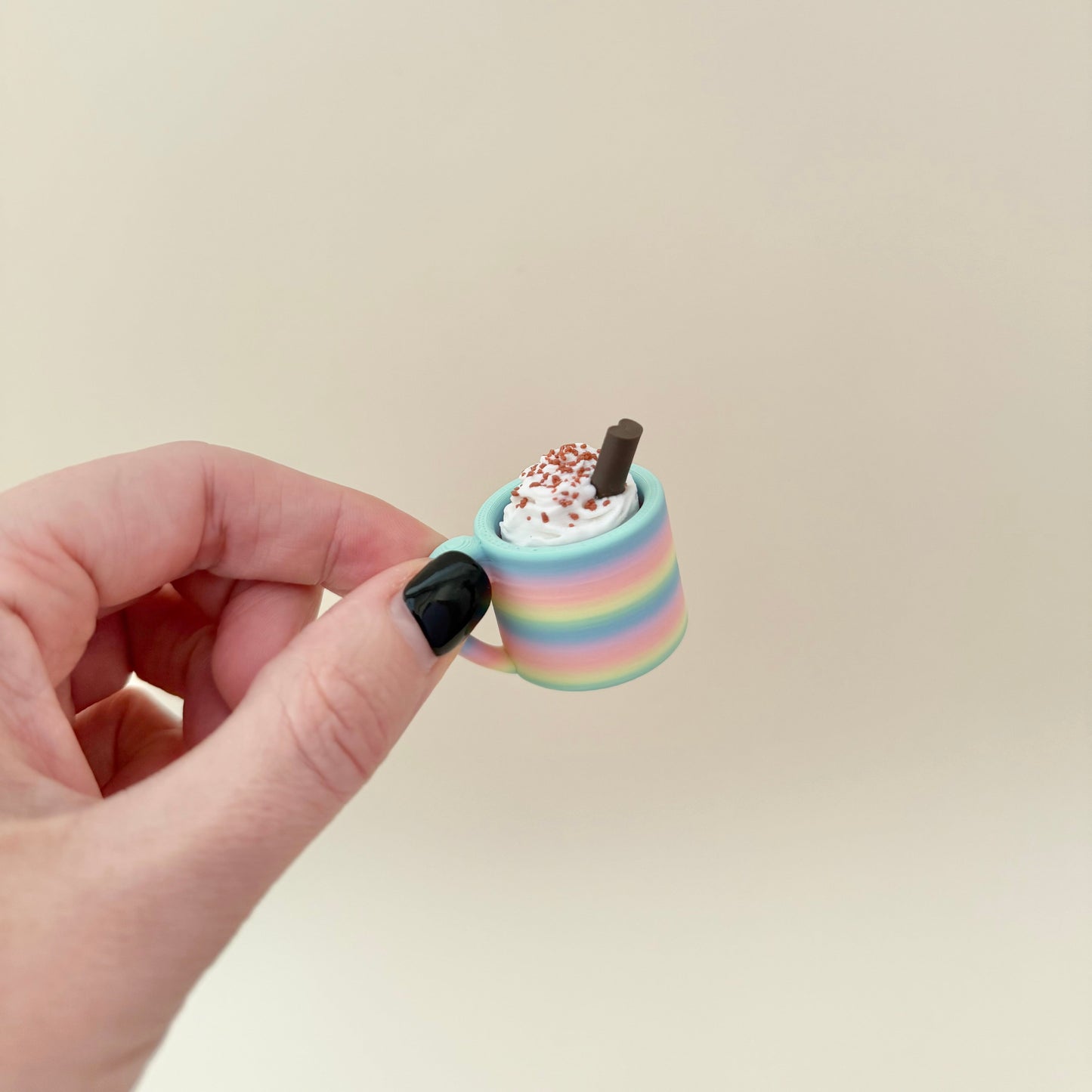 Mug-shaped sensory fidget with whipped top; choose colour, topping and click or quiet; portable desk-friendly size.
