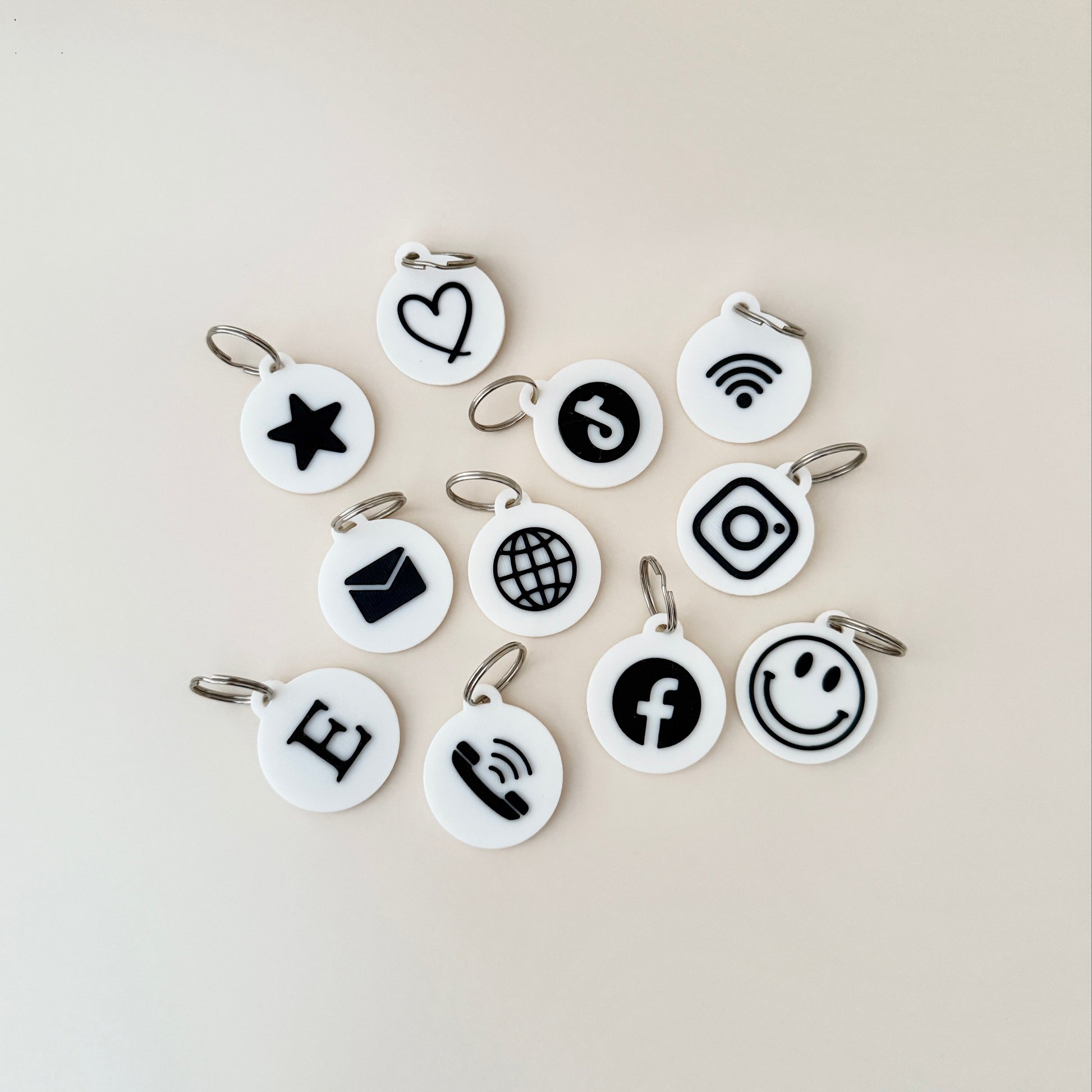 A selection of NFC keyrings featuring different icons, including a star and TikTok logo, designed for easy programming and versatile use.