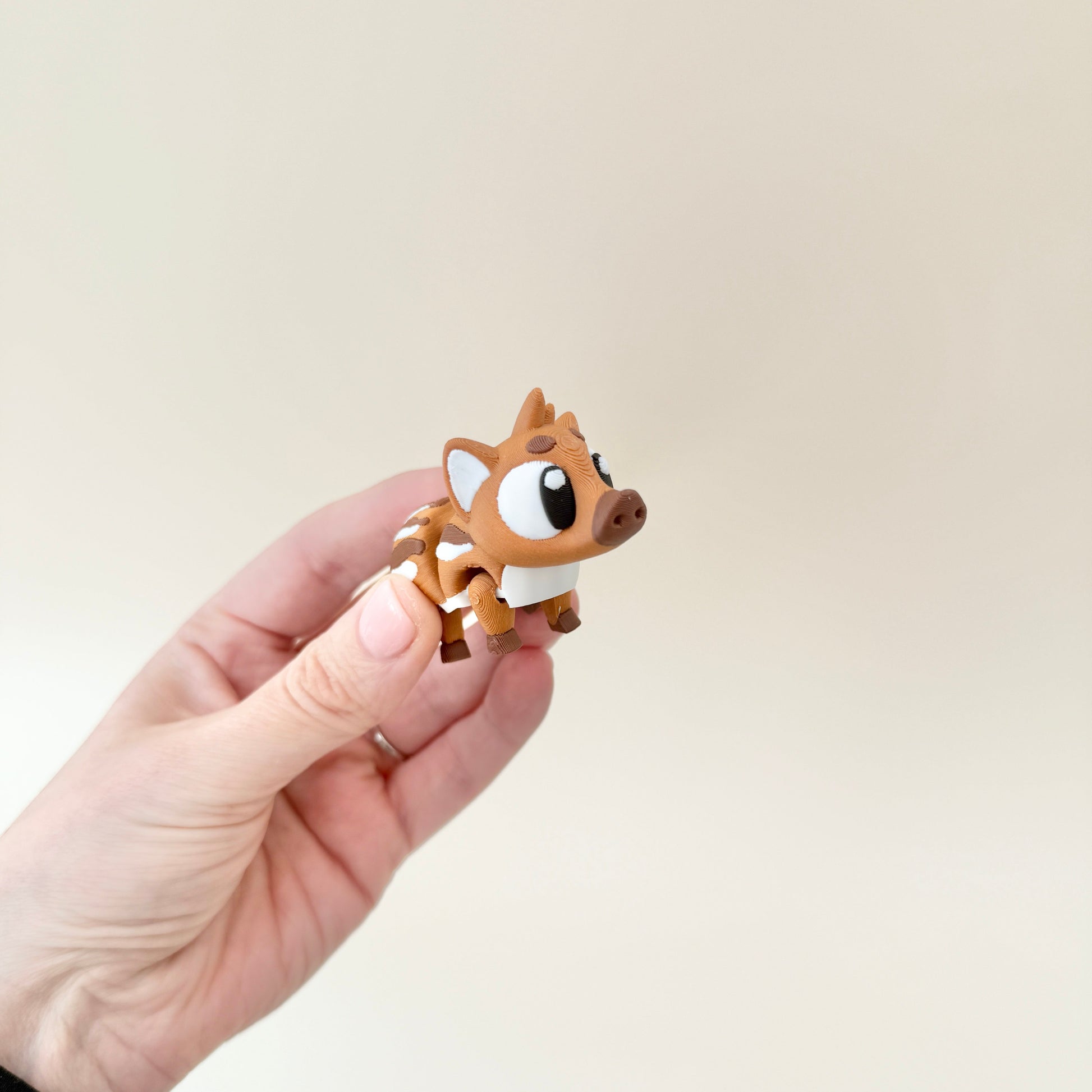 A pocket-sized baby boar fidget with detailed white markings and a fully flexible design.