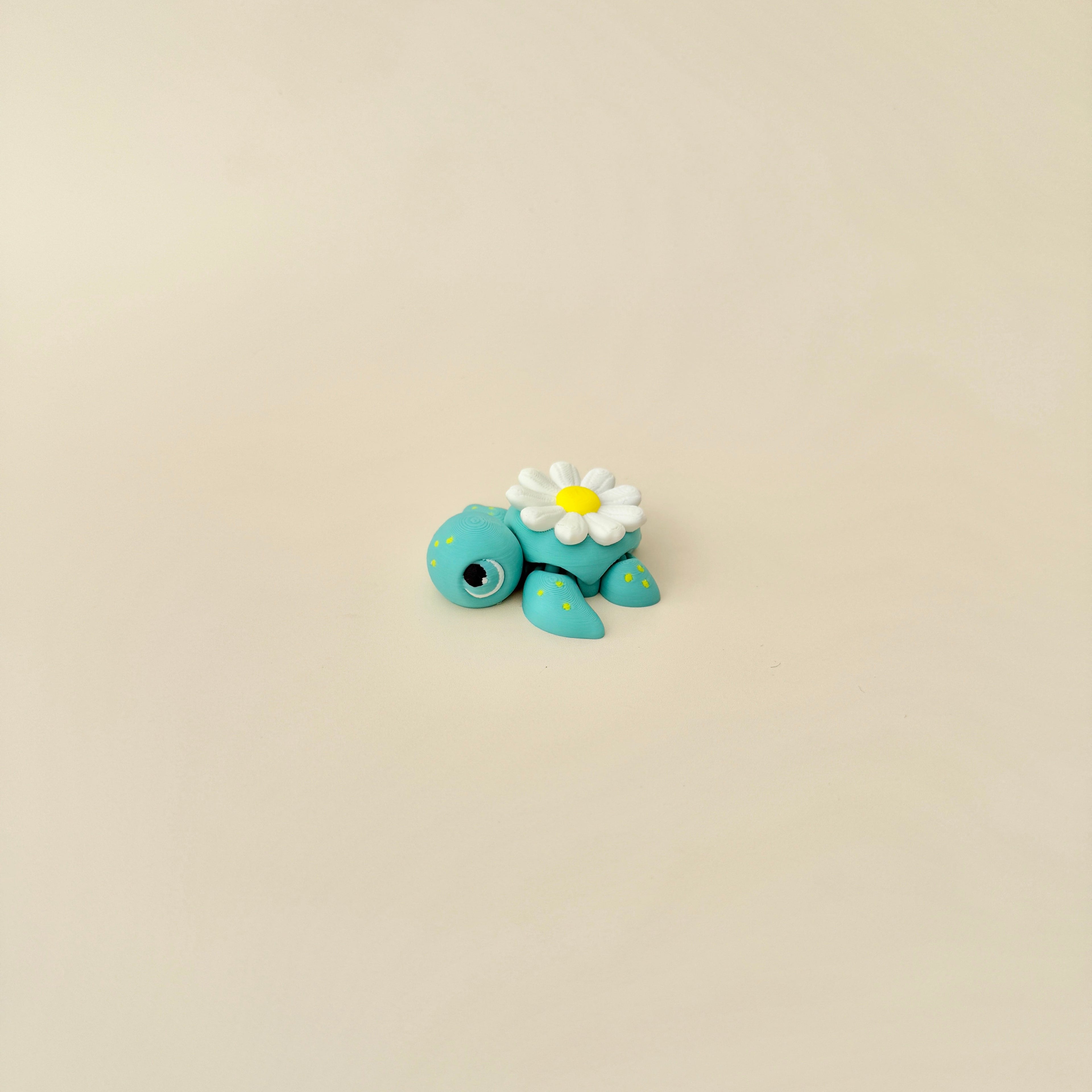 A small, flexible turtle fidget toy with floral details, designed for sensory enjoyment.