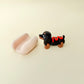 Removable bun with raised details and articulated dog for tracing and tactile input.
