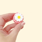 Portable flower-shaped fidget toy with tactile top and smooth click action.
