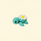 A 5cm teal fidget turtle with a yellow-speckled body and a daisy design on its shell.