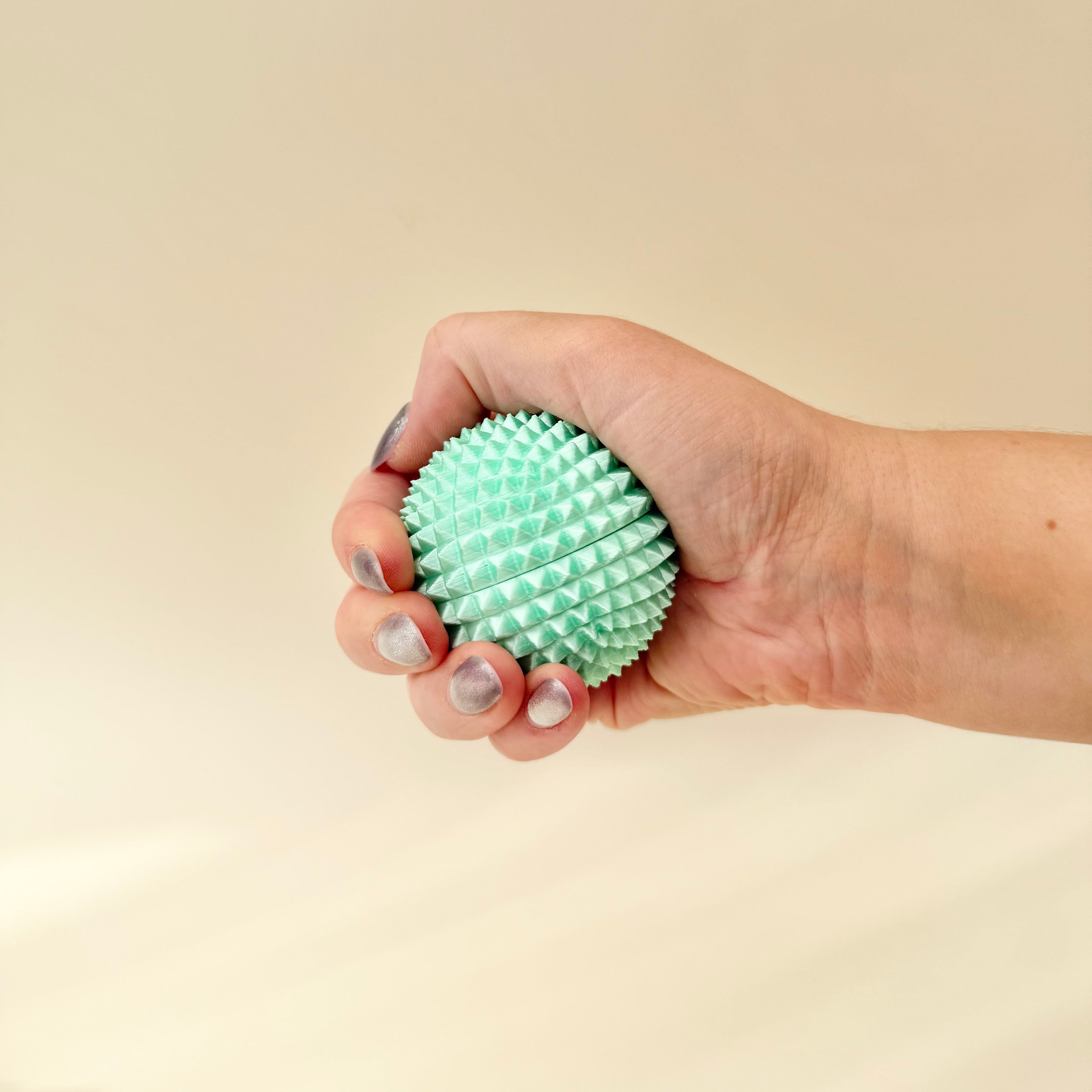 Solid spiked sensory support piece for squeezing, rolling on skin and strong tactile input without noise.
