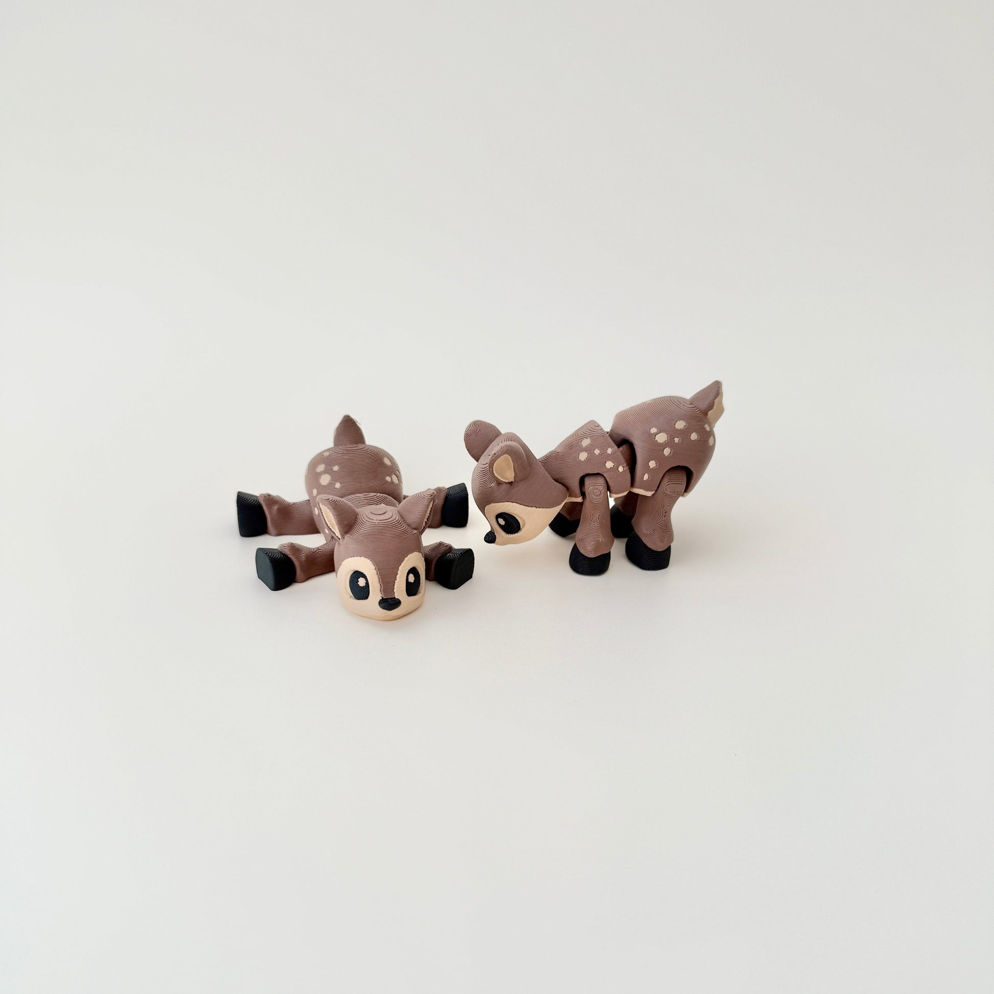 Deer fidget toy shown lying flat, showcasing its detailed body and flexible design.
