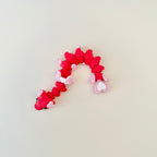 14 cm articulated serpent with gentle wiggle and heart tail; neurodivergent-friendly handheld fidget for focus and calm.
