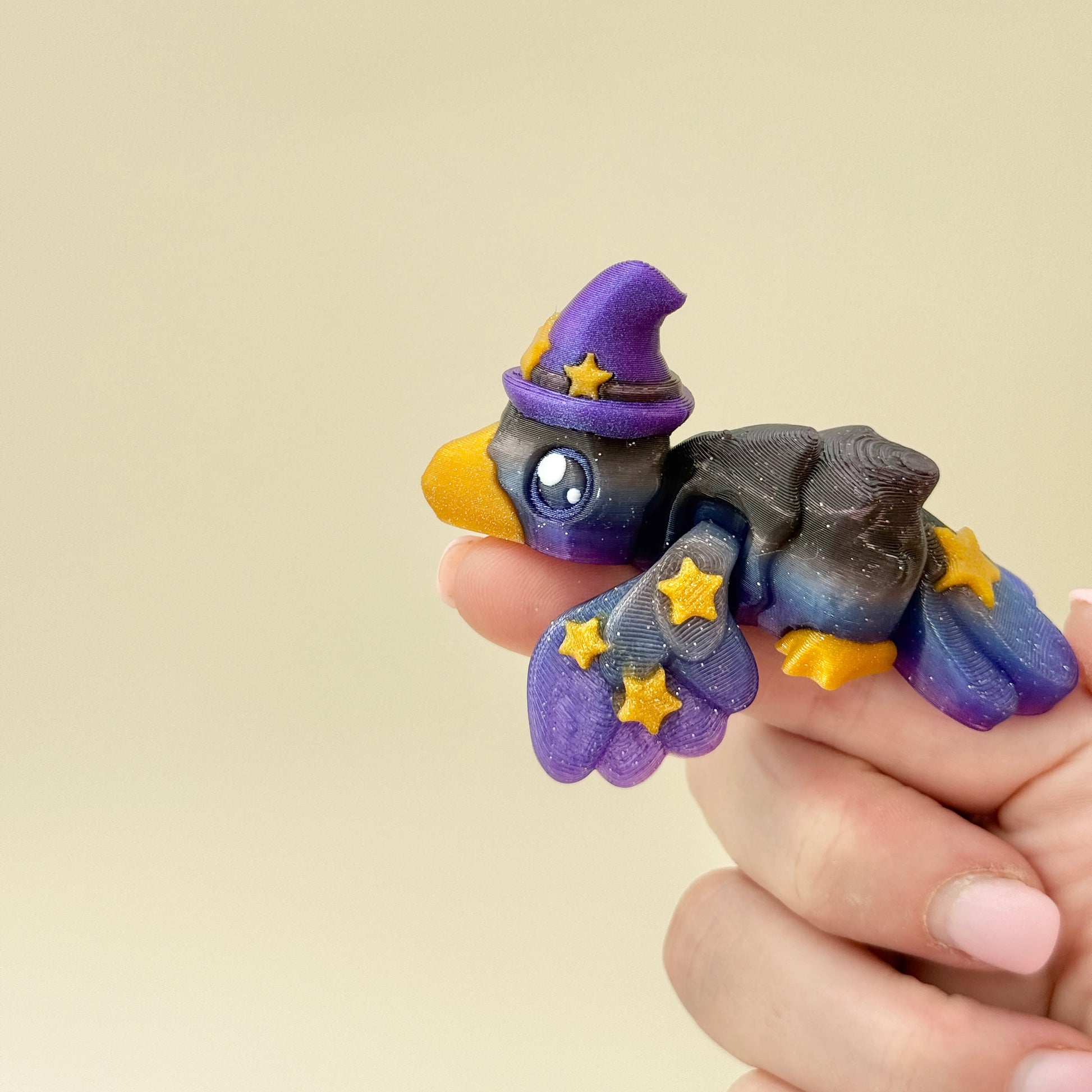 Compact crow that sits flat or hugs a finger for gentle sensory play.

