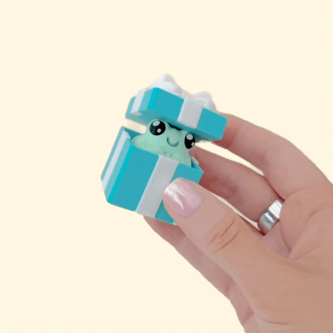 Present-shaped fidget; rounded contours and solid click for quick focus breaks.
