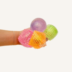 Quiet textured squishy fidget with slow-rise rebound, grippy bumps and glittery visual sparkle for sensory calming.
