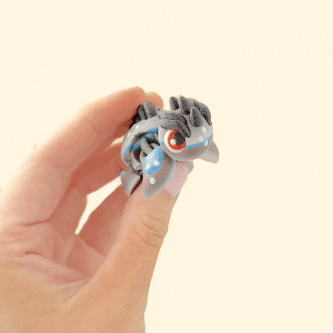 Gradient turtle fidget toy with black glittery spikes, red eyes, and dragon-like detailing for sensory play.