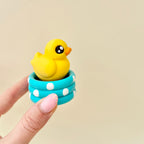 Chunky duck sensory clicker with push-down action and playful pond design for repetitive pressing.
