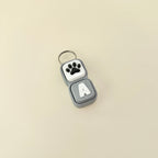 Keychain with paw print and letter 'A' on a beige background