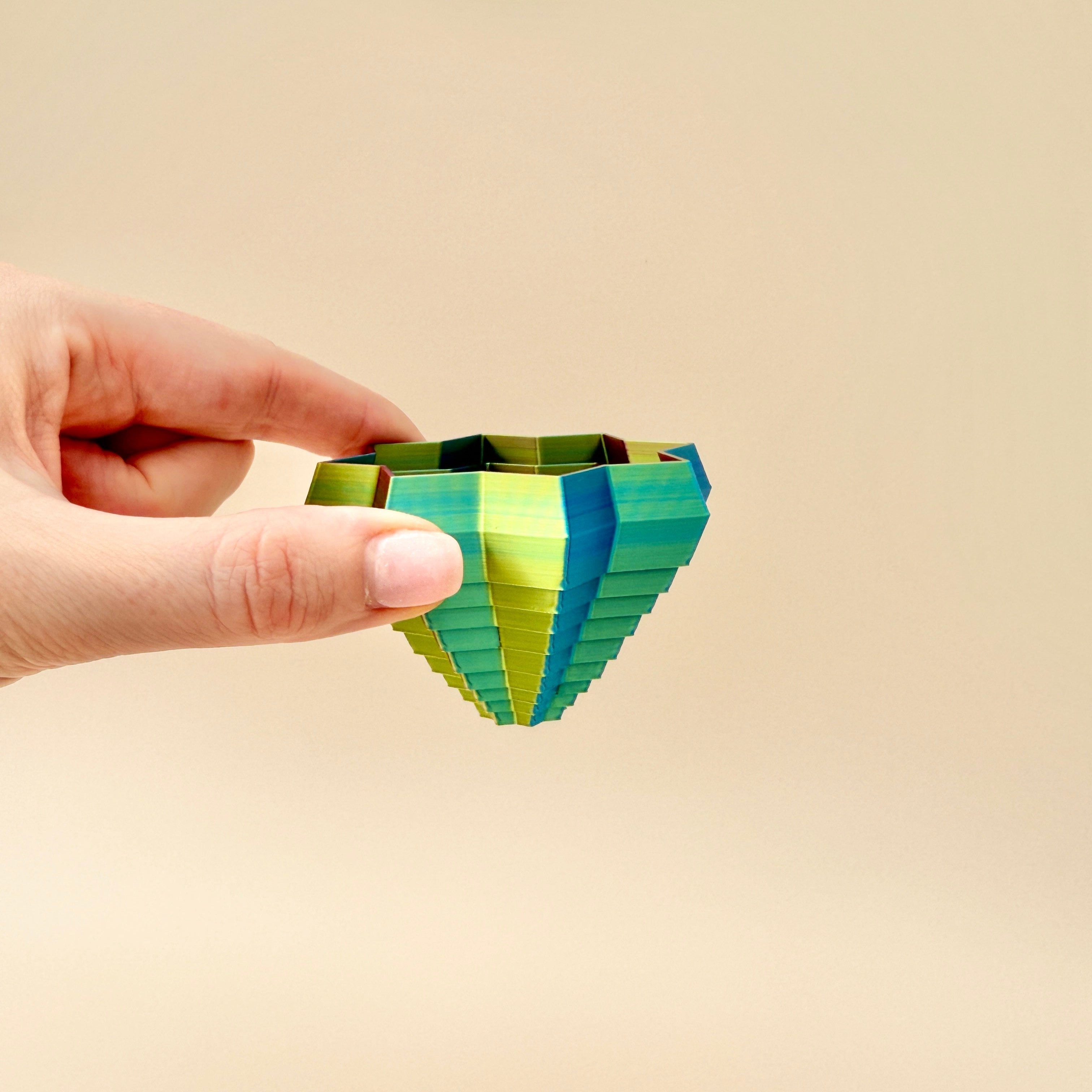 ShapeShifters Star toy shown with cascading layers, showcasing its dynamic movement. Sensory star design