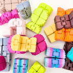 Portable handheld fidget that folds into different shapes with a smooth feel and subtle texture for calming sensory input
