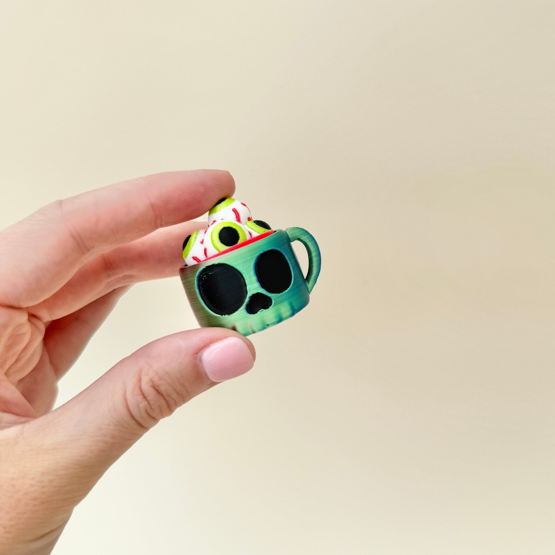 compact cup-shaped clicker fidget with tactile eyeball press
