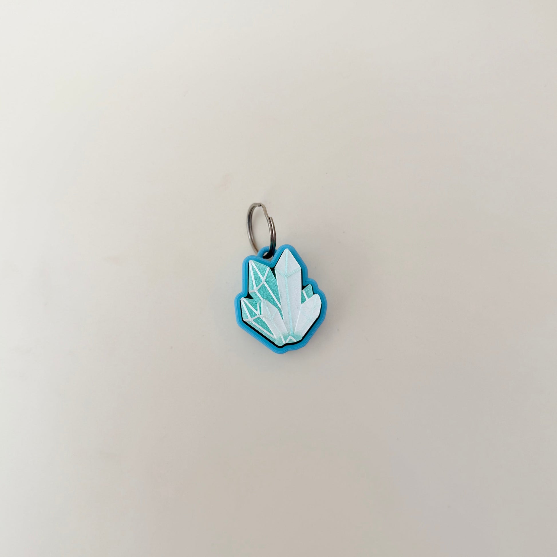 Compact crystal-shape fidget with raised edges; satisfying click action; quiet click upgrade available; everyday carry friendly.