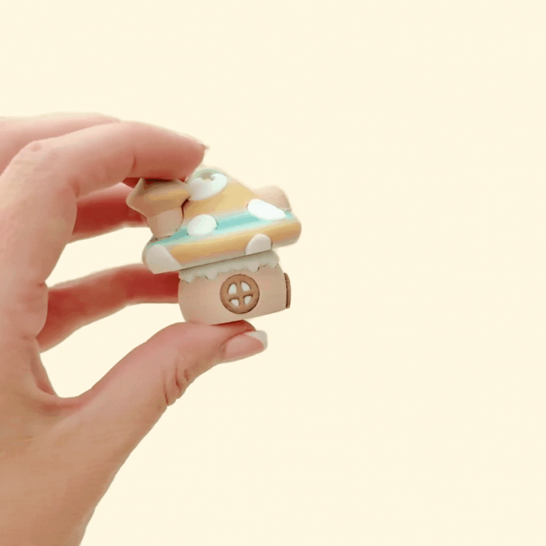 Palm-sized mushroom house fidget with soft textures and click action
