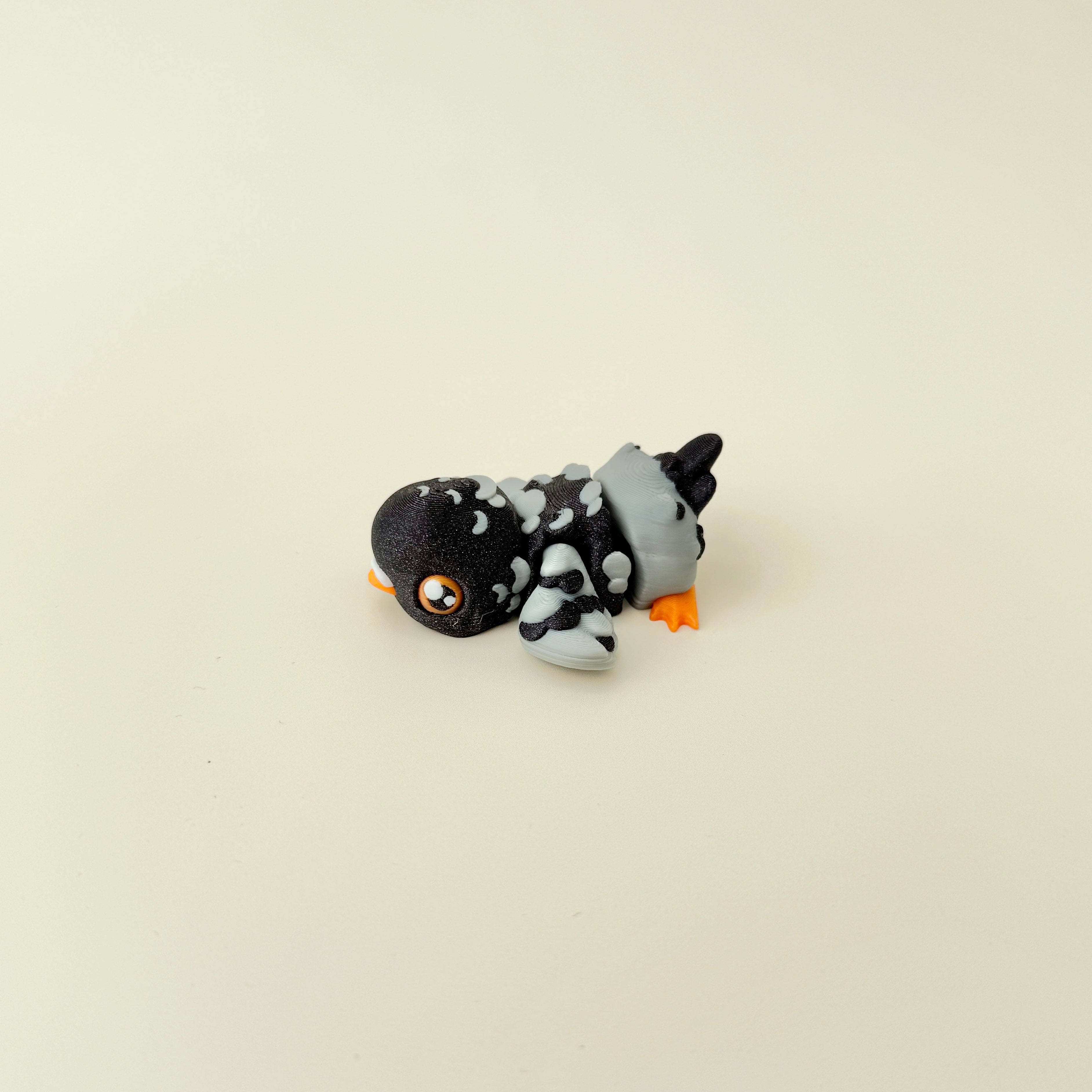 Grey and sparkly black pigeon fidget toy with realistic detailing and articulation.