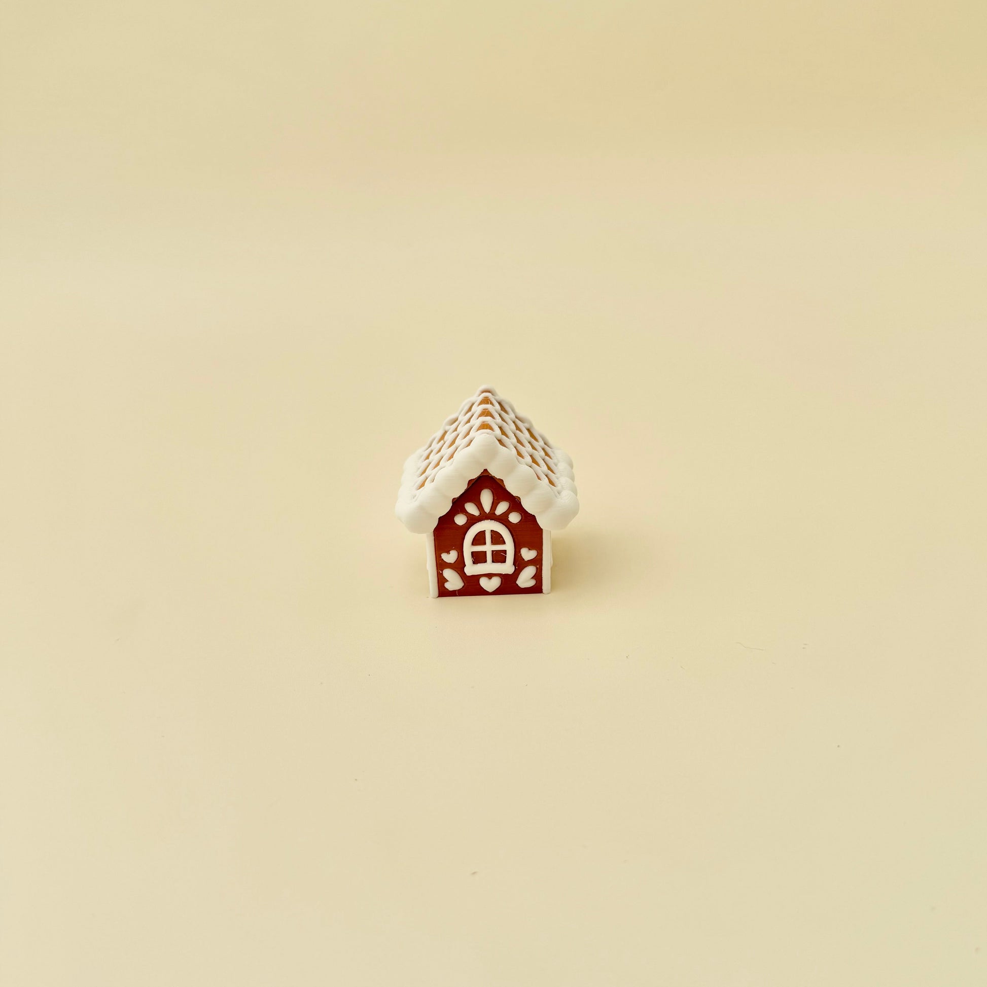 Christmas gingerbread house fidget; plastic clicker with raised icing pattern and optional quiet click mechanism.
