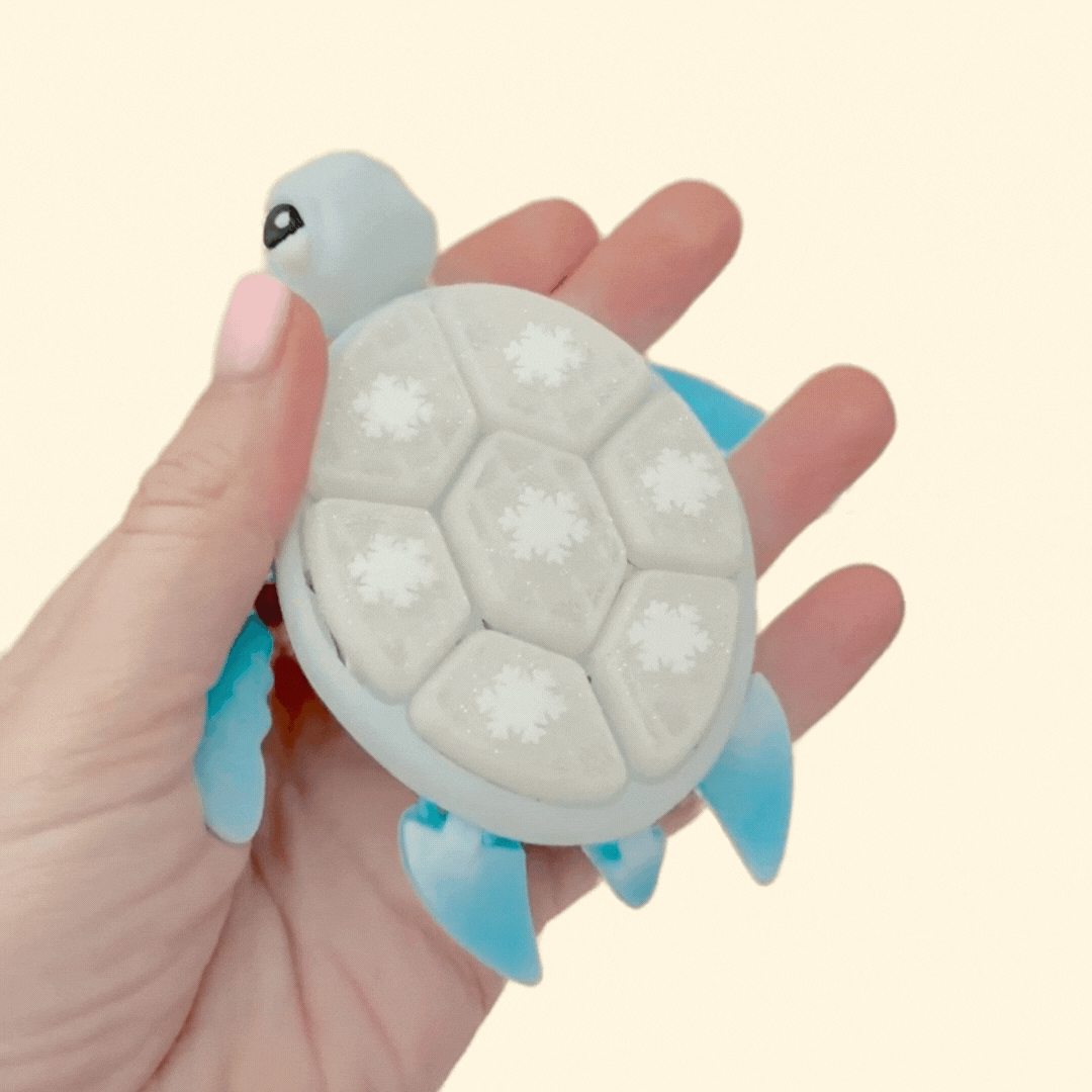 Holiday turtle clicker, durable plastic, rhythmic clicking for regulation and fidget relief.
