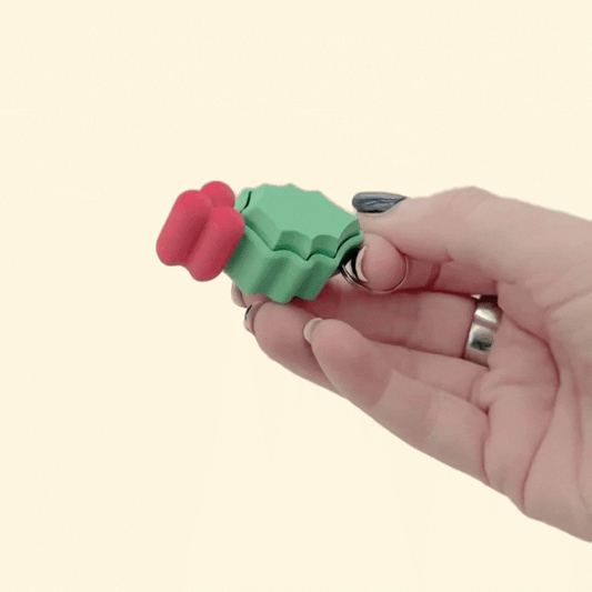 Flat Christmas holly click fidget with red berries, keyring loop attached, good for tracing and light regulation.
